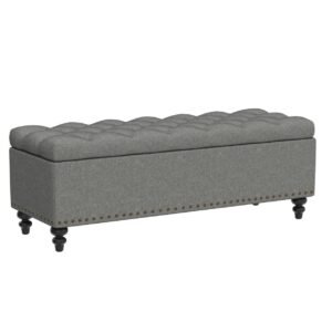 An extra long end of bed bench with a 70-inch upholstered seat in cream boucle, styled at the foot of a California King bed in a high-end master bedroom.