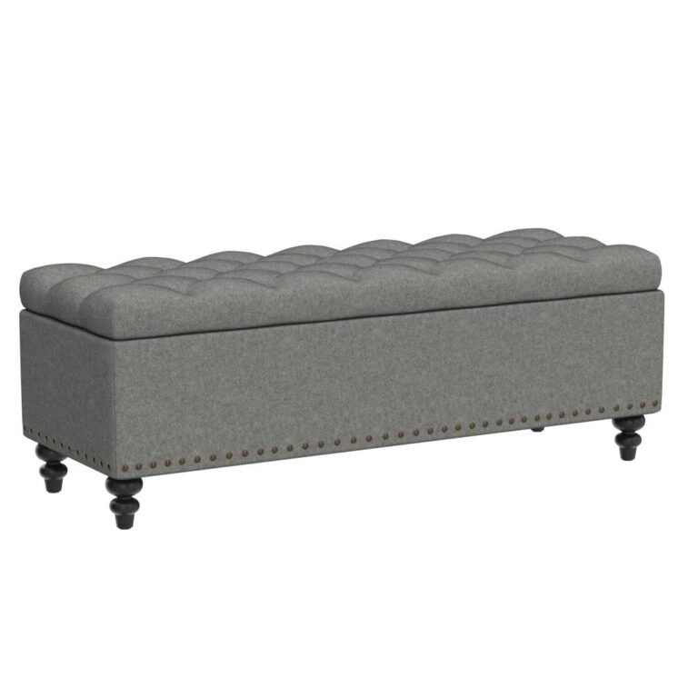 An extra long end of bed bench with a 70-inch upholstered seat in cream boucle, styled at the foot of a California King bed in a high-end master bedroom.