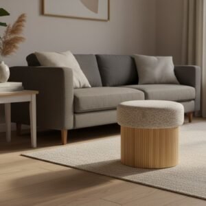 Compact round wooden storage bench placed next to a sofa in a minimalist home