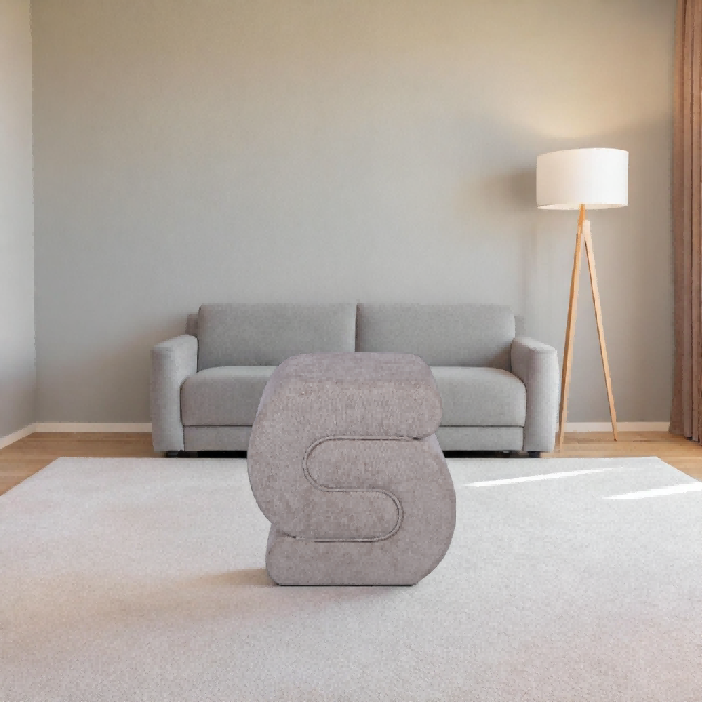 Custom grey fabric S-shaped footstool from a leading ottoman manufacturer for modern living room decor.