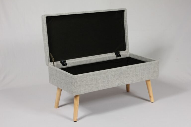 A narrow entryway bench with storage in a compact modern apartment hallway, featuring boucle fabric and slim design.