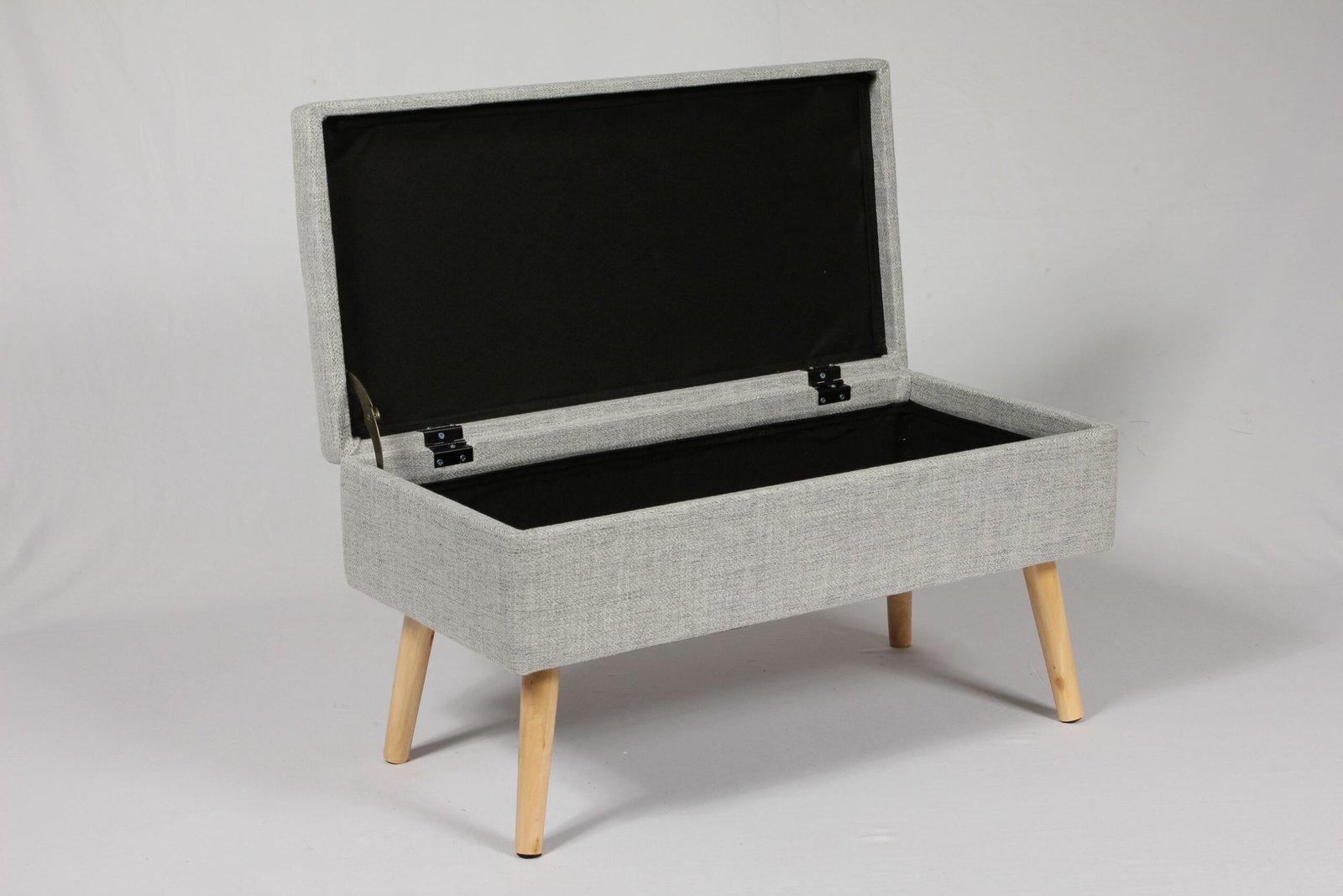 A narrow entryway bench with storage in a compact modern apartment hallway, featuring boucle fabric and slim design.