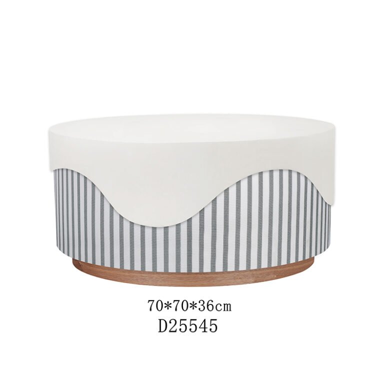 A round velvet ottoman with its lid removed, showing hidden storage space for blankets and pillows.