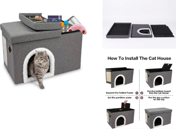 A close-up of an open grey pet house revealing a pink strawberry-print cushion and various cat supplies. A grey cat walks through the plush-lined front portal, with the open lid leaning against the side.
