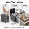Product showcase of a collapsible grey ottoman from FZ Victor. The image highlights the space-saving design by showing the ottoman body folded completely flat next to the tufted seat cover and the assembled cube with a side storage pocket.