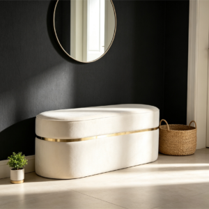 Elegant cream upholstered oval storage bench with gold trim in a contemporary interior setting.