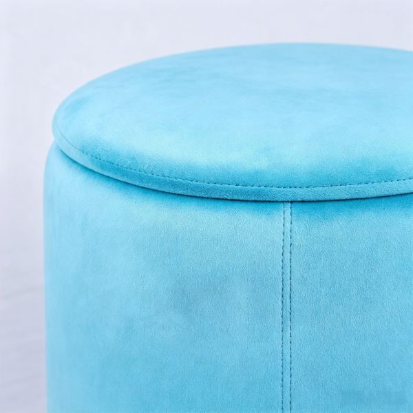 Light blue velvet oval storage stool used as a coffee table in an elegant living room with classic decor.