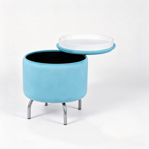 Modern light blue oval velvet storage footstool styled next to a blue sofa in a contemporary living space.