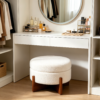 Modern white round coffee table with ottomans styled near vanity desk in bedroom