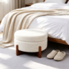 Modern white round coffee table with ottomans styled near vanity desk in bedroom