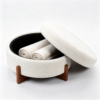White round textured fabric coffee table with ottomans set in contemporary living room