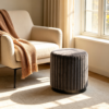 Two dark gray fluted velvet storage ottomans styled together in a modern living space.