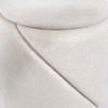 Close-up view of a small round white textured fabric storage ottoman coffee table
