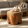 Square fabric upholstered ottoman used as a coffee table with tray and decor