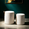 Nested round ottoman and coffee table set with brown leather handle detail