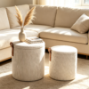 Close-up view of fabric texture and brown leather handle on a round ottoman