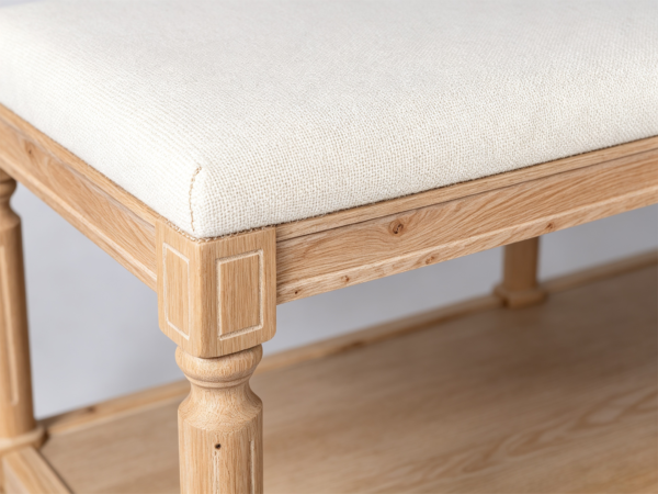 Cream tufted rectangular footstool bench featuring solid wood frame and open lower storage tier