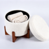Open white teddy boucle round storage ottoman displaying interior hidden storage space