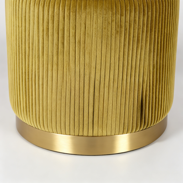 Close-up of a mustard yellow pleated velvet round storage ottoman with a brushed gold metal base