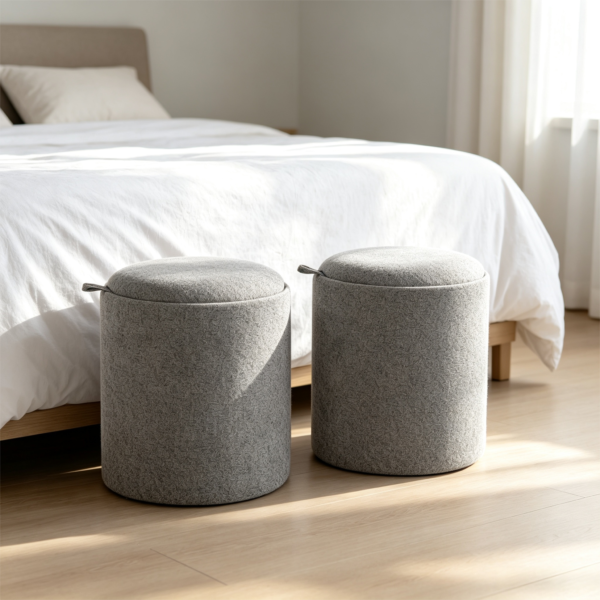 Close-up view of the minimalist leather accent handle on a grey round fabric storage ottoman